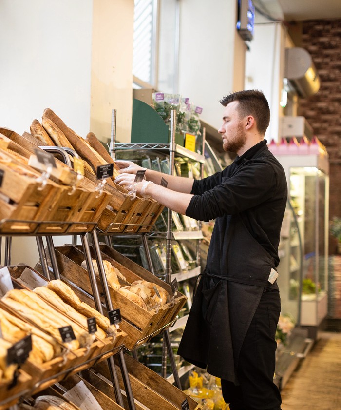 Bread being stocked in the Food Hall